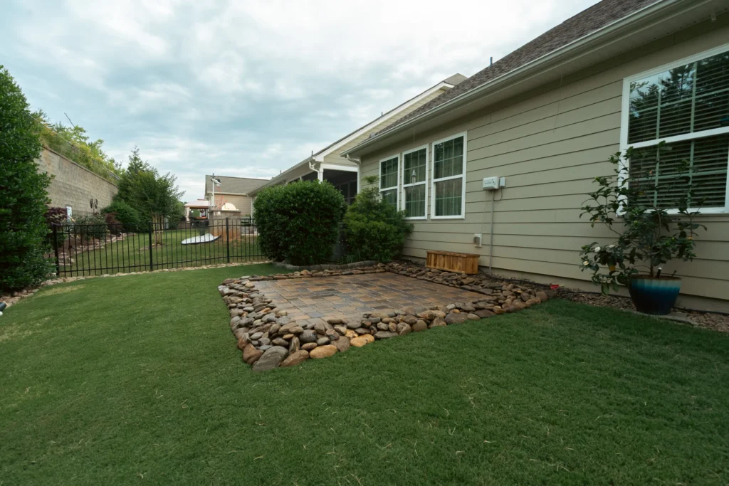 Paver pad with river rock border wide view — Clover SC